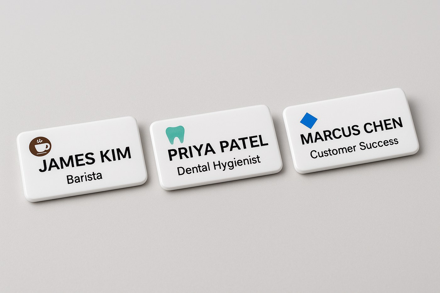 Three custom name badges showing different company logos: a coffee shop, a dental practice, and a tech firm