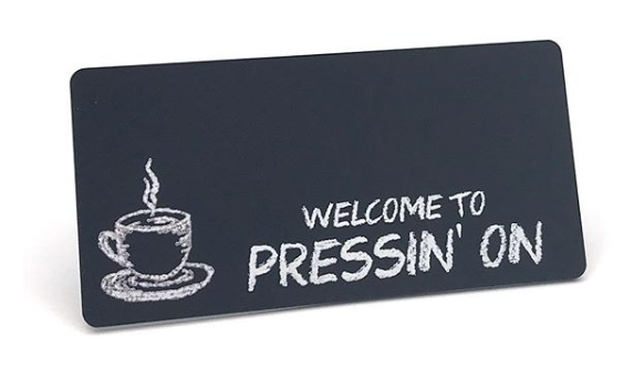 Chalkboard name badge examples showing different writing styles with chalk and markers