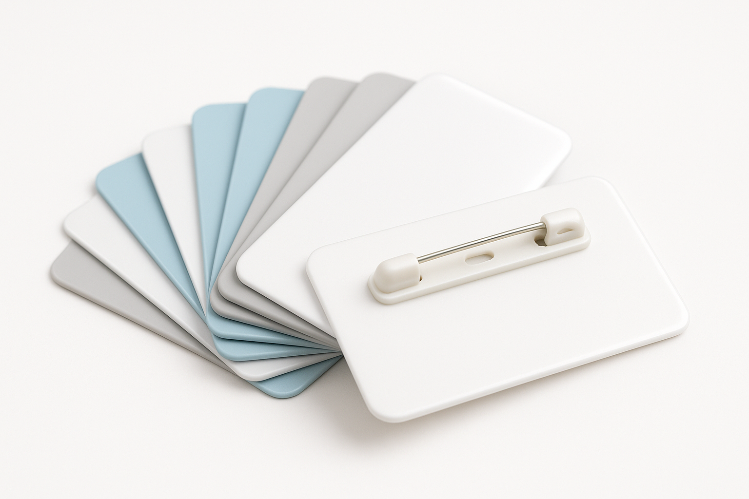 Stack of cheap plastic name badges in white and light colors with pin fasteners, high quality finish