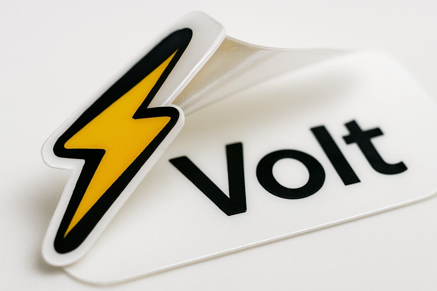 Close-up of a die-cut lightning bolt vinyl sticker being peeled from its backing paper